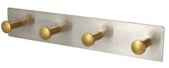 Rostfritt kroklist med fyra runda guld-färgade knoppar för badrum.