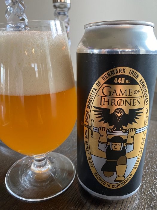 Ett glas IPA-öl bredvid en burk med Game of Thrones-tema från Mikkeller Brewery.