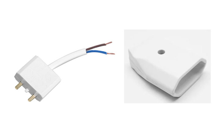 Ojordad kontakt och skarvsladd för LED-slinga, 12V adapter vid sidan av vit kabelkanal.