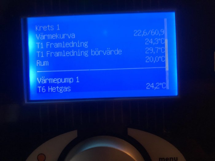 Digital display av en värmepump med temperaturvärden och statusinformation.