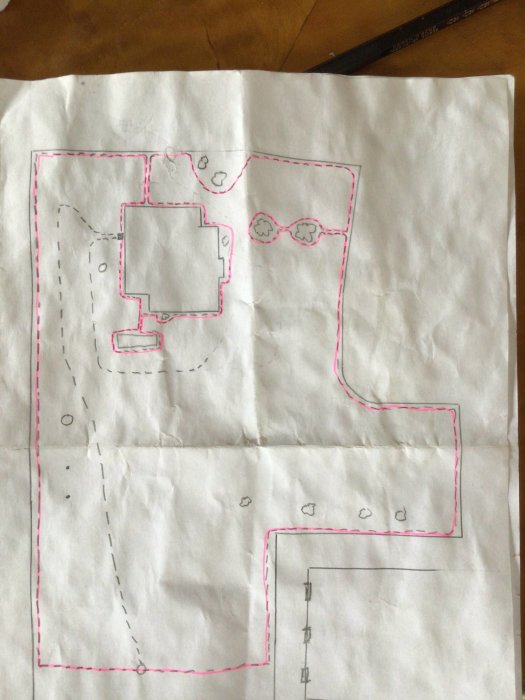 Handritad skiss av en trädgårdplan med markerade guidekablar för laddstation.