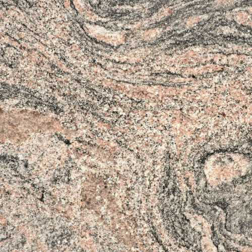 Närbild på en granitbänkskiva med varierande rosa och gråa nyanser.