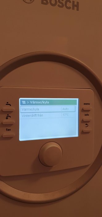 Display av en varmepump med inställningsmenyn öppen, visar 'Värme/kyla: Auto' och 'Vinterdrift från 17°C'.