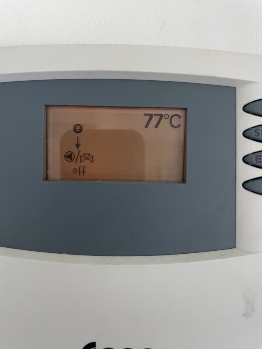 Display av en pelletsbrännare som visar en temperatur på 77 grader Celsius.