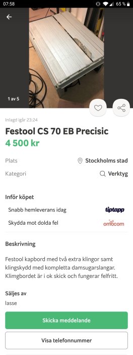 Bordssåg Festool CS 70 EB i använd skick på ett golv, sågblad synligt, inga personer.