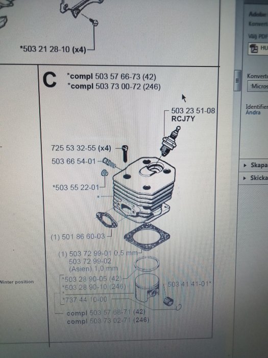 Explosionsritning av motor med tändstift och komponentlistor.