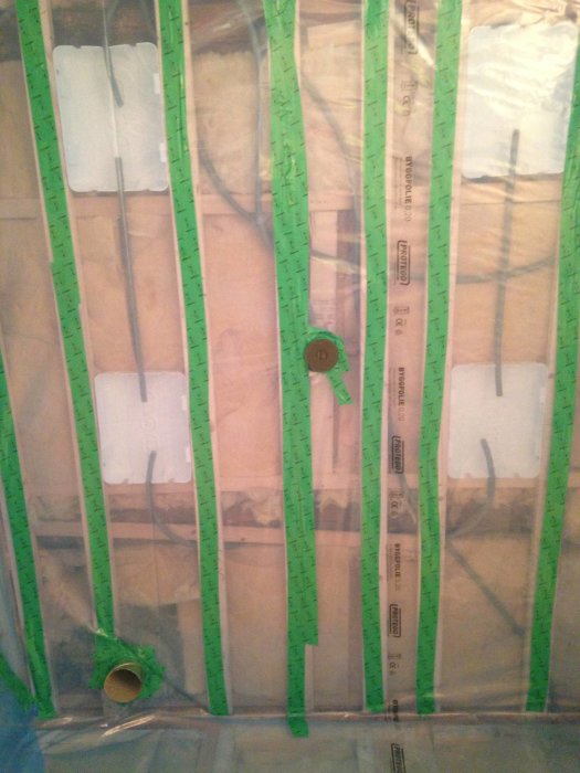 Diffusionsspärr monterad på glespanel med tejpförseglade häftpunkter i ett pågående badrumsbygge.