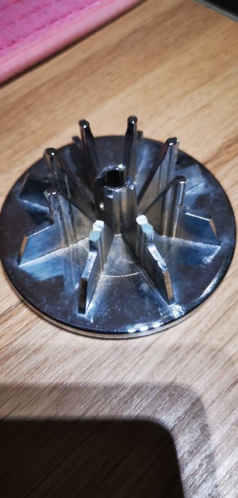 Närbild av trasiga metalliska delar av en konstruktion, med fokus på skadade kanter och ytor.