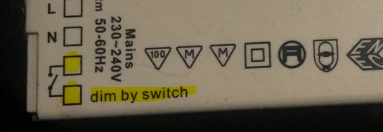 Kontrollpanel med märkningar för dimmer och instruktioner, angiven som "dim by switch".