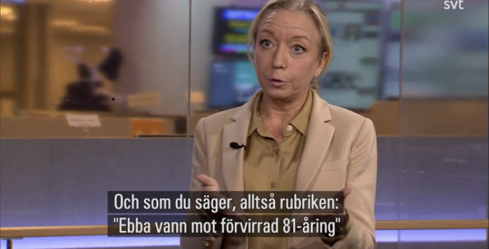 Kvinna i beige kavaj intervjuas i TV-studio med textning om domstolsfall.