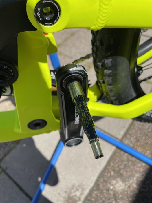 Pedalaxel med färgstänk på en gul cykel där axeln sannolikt inte passar i kopplingen.