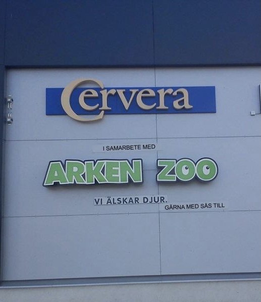 Skylt på byggnad med texten "Arken Zoo - Vi älskar djur, gärna med sås till".