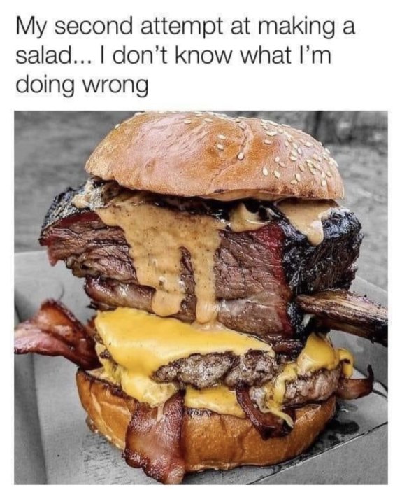 Juicy hamburger med cheddarost, bacon, och flera lager biff på ett sesambulle.