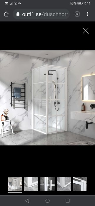 Vit duschhörna med svarta detaljer i ett modernt badrum med marmormönstrade väggar.