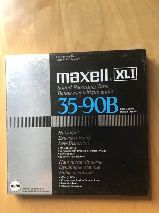 Ett oöppnat Maxell XLII 35-90B ljudband för analog inspelning på en träyta.