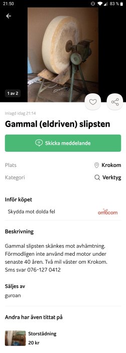 Gammal elektrisk slipsten med stor rund vit sten och grön metallbas.