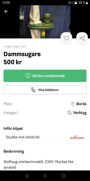 Industriell dammsugare för snickeri, grön och grå, lätt använt skick, mot blå bakgrund.