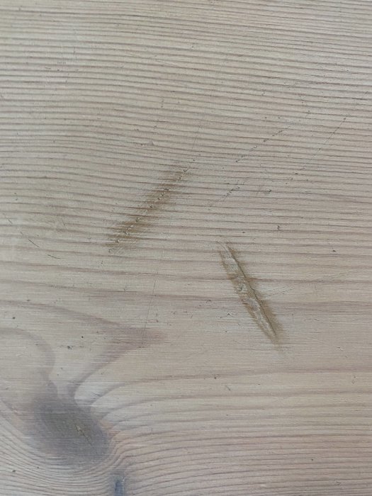 Närbild av vitvaxat furugolv med synliga repor och ådring, behandlat med Osmo.