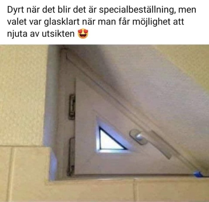 Litet trekantigt fönster installerat i hörnet av ett rum med en glimt av himmel, ackompanjerat av ironisk text.