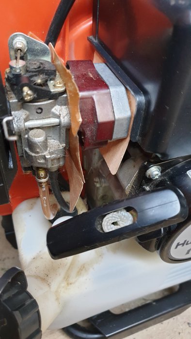 En motorsågsdel med tydliga läckagespår vid fästet.