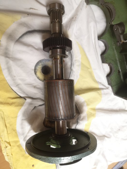Motoraxeldelar ihopsatta efter lagerbyte, med rengjorda stator- och rotor-ytor, på en vit och gul trasa.
