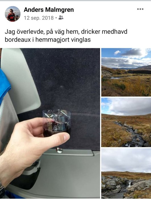 Hand håller ett vinglas med rödvin ombord på ett flygplan, med naturvy genom fönstret.