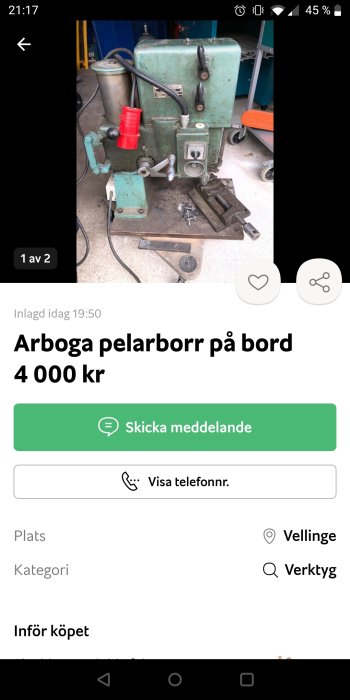 Begagnad grönmålad Arboga pelarborr placerad på ett grått betonggolv.