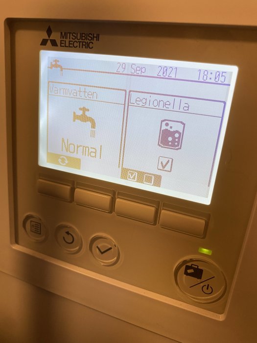 Display på värmepump med låst Legionella-inställning och ikonen för låsning aktiverad.
