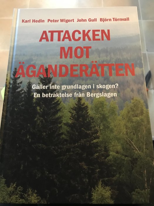 Bokomslag för "Attacken mot äganderätten" med skogsbild och författarnamn.