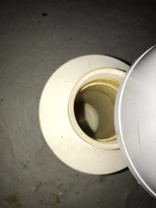 Översikt av ett rör i badrumsgolvet där man misstänker att avloppslukt uppstår.