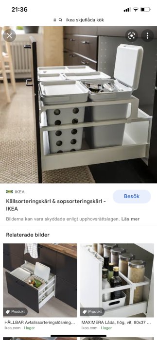 Vitt avfallssorteringssystem med flera lådor och öppet lock i ett kök.