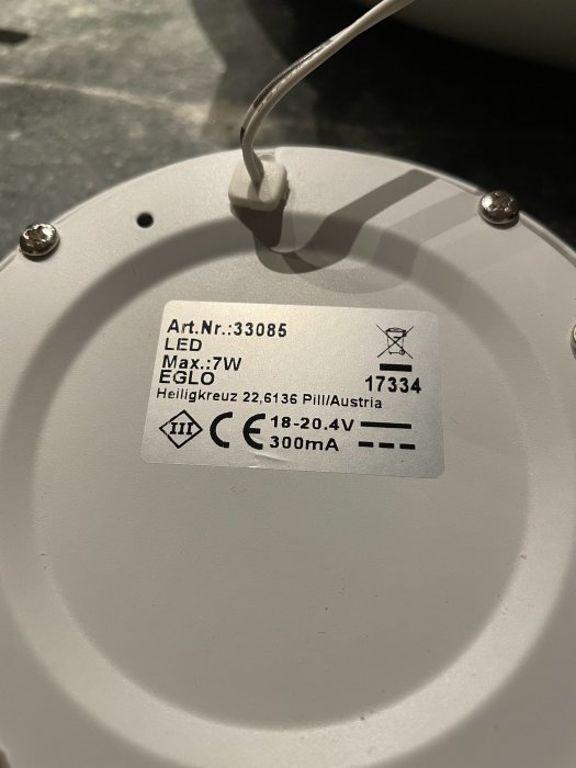 Närbild av en LED-spotlights baksida med tekniska specifikationer och elektrisk anslutning.