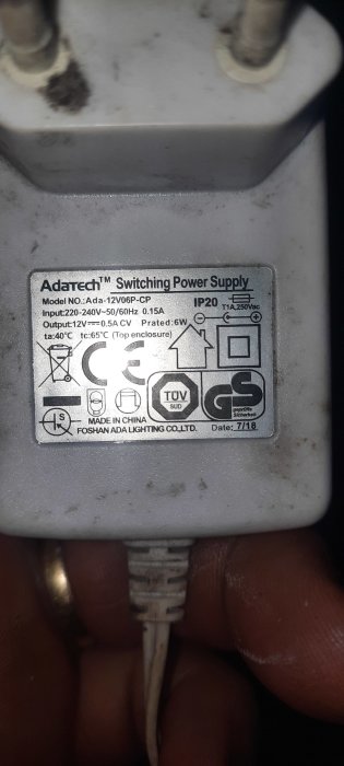 Närbild på etikett för Adatech Switching Power Supply med tekniska specifikationer och säkerhetsmärkningar.