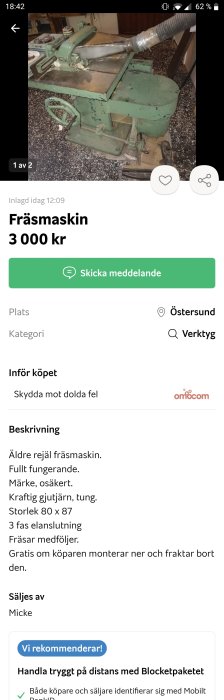 Äldre grönmålad fräsmaskin av gjutjärn, synlig slitage, med dammutsugningsrör, i en verkstadsmiljö.