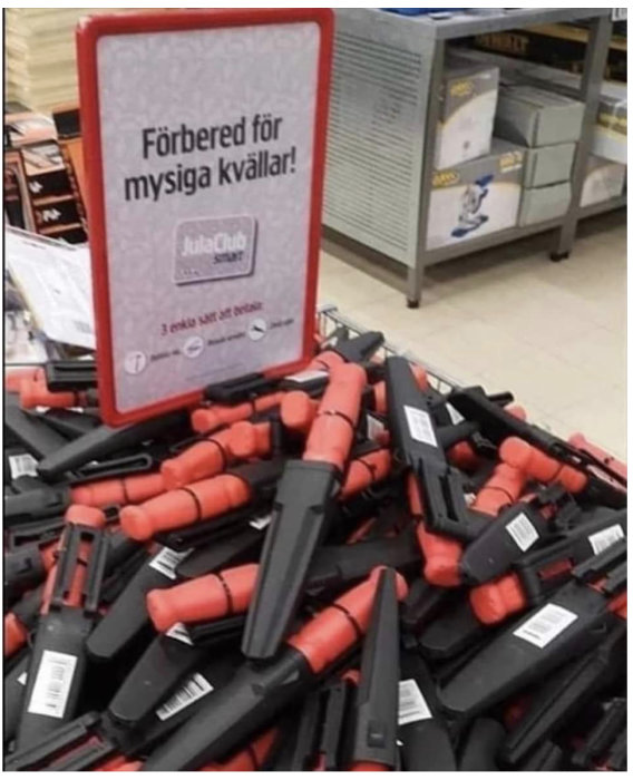 Hög med röda och svarta tångliknande verktyg i en butiksdisplay med skylt uppmanande till förberedelse för mysiga kvällar.