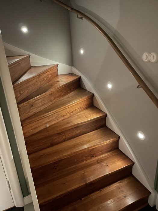 En trätrappa behandlad med Osmo hårdvaxolja under inbyggda spotlights.