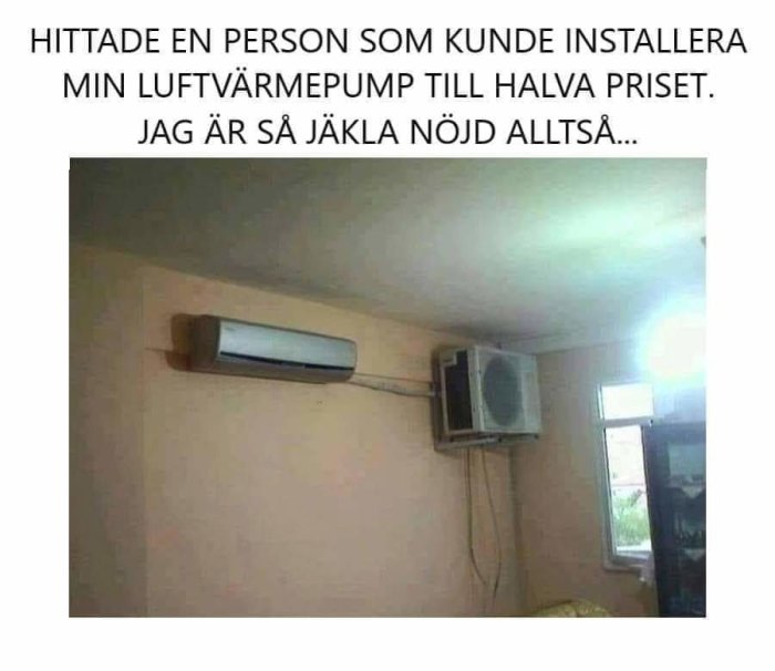 Luftvärmepump felaktigt installerad med inomhusdelen på väggen och utedelen hängande inomhus.