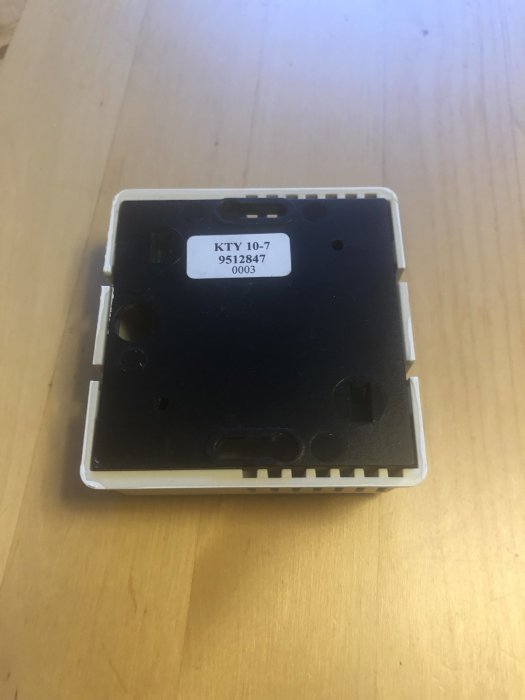 Gammal rumsgivare på ett träbord med tydlig etikett som visar modellnummer KTY 10-7.