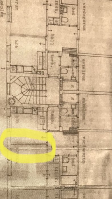 Arkitektritning av en bostadsplan med en vägg markerad med gult som planeras tas bort för renovering.