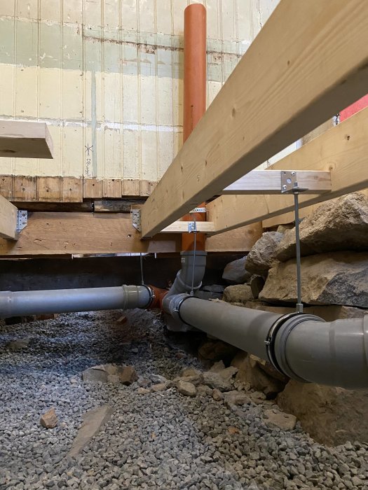 Nya rörinstallationer under bjälklag i pågående badrumsrenovering.