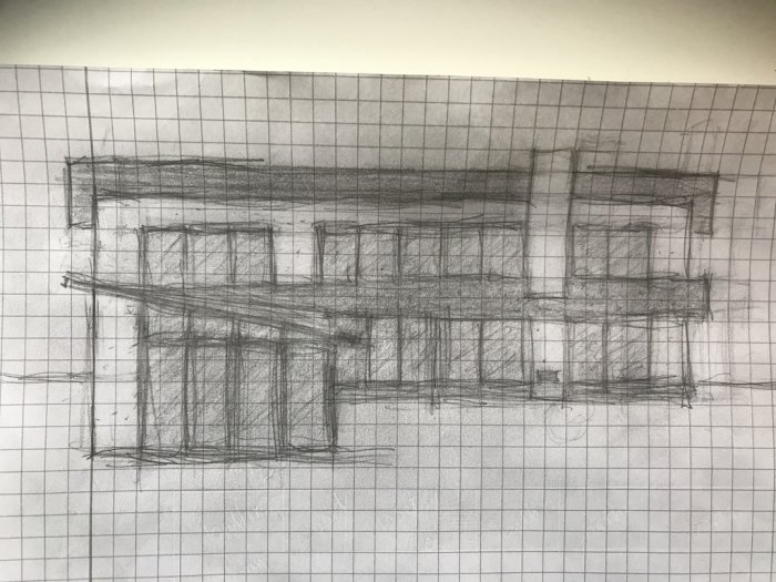 Skiss av en byggnad med flera fönster på rutat papper.