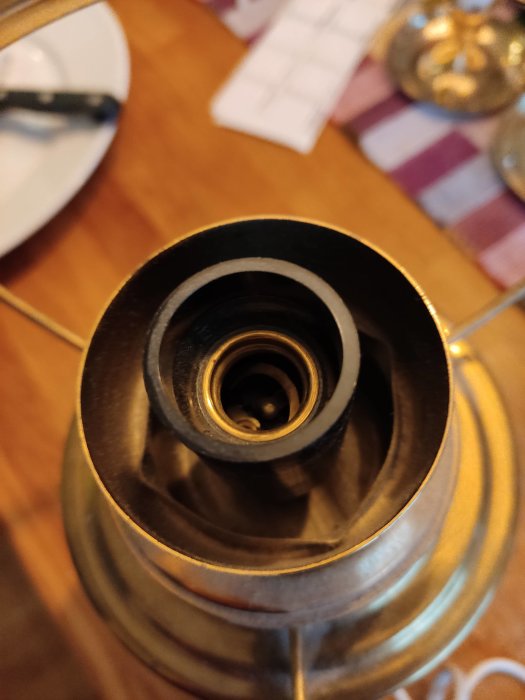 Närbild på en ojordad lampsockel inuti en metallampa som behöver jordas.