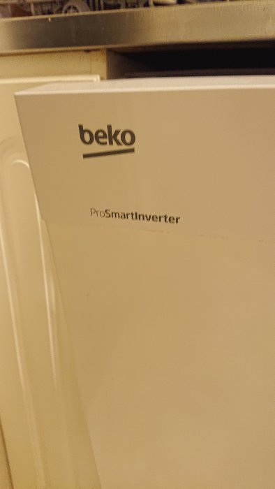 Närbild av en vit Beko diskmaskin med ProSmartInverter-teknologi.