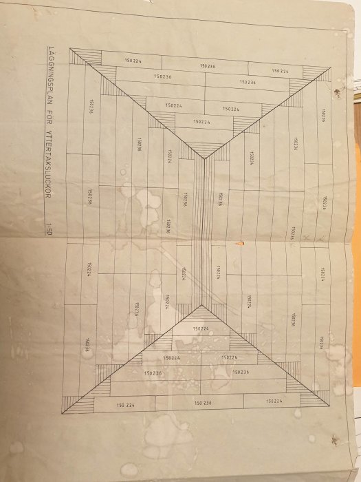 Sliten arkitektonisk ritning av byggnadslokaliseringsplan med mått och linjer, fläckig och något veckad.