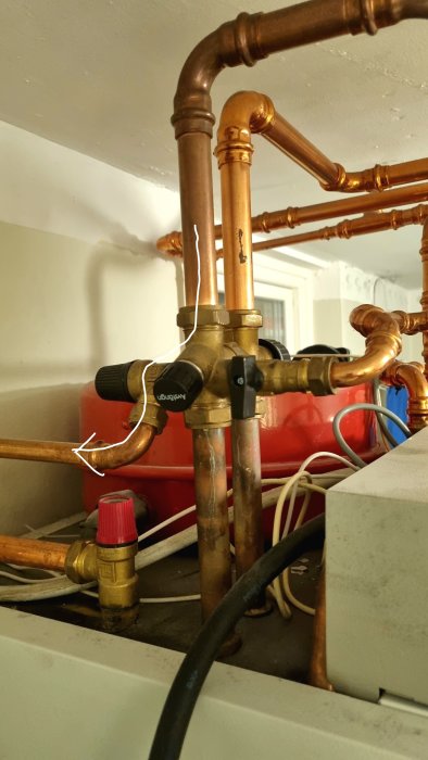 Copper piping and safety valve on a CTC Echoheat 7.5 heat pump, indicating maintenance needs.