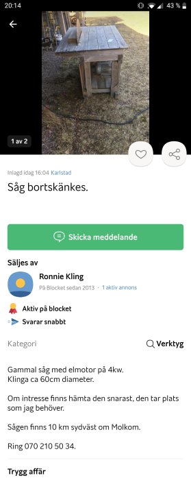 Gammal såg med en elmotor och en klinga på en träbänk utomhus som bortskänkes.