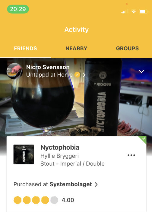 Ölglas med mörk Stout framför en aktivitetsflik i en ölapp, en ölburk med texten "Nyctophobia".