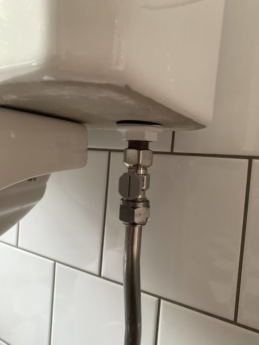 Kopplingen till en toaletts cistern, sannolik plats för filter som behöver rengöras.