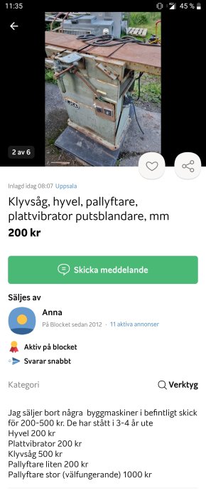 Använd begagnad grön klyvsåg står utomhus med sladdar och rostiga detaljer.