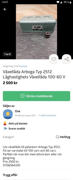 Grön växellåda av typ Arboga 2512 med skala och tandkugghjul framför på ett bord.